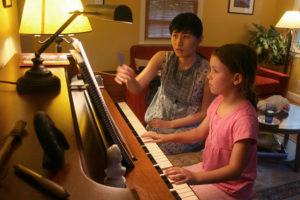 Teacher and student at the keyboard