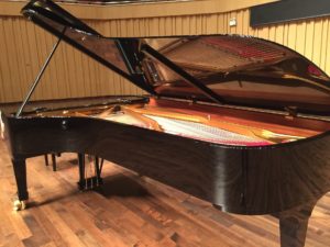 Large Steinway piano on stage with lid up